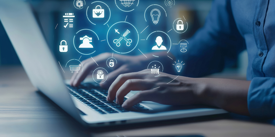 Hands typing on a computer keyboard, overlaid with interconnected icons representing digitalisation, networking and modern technology.